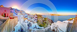 Oia town on Santorini island, Greece. Traditional and famous houses and churches with blue domes over the Caldera, Aegean sea.