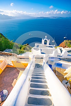 Oia town on Santorini island, Greece. Traditional and famous houses and churches with blue domes over the Caldera, Aegean sea.