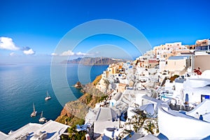 Oia town on Santorini island, Greece. Traditional and famous houses and churches with blue domes over the Caldera, Aegean sea