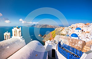 Oia town on Santorini island, Greece. Traditional and famous houses and churches with blue domes over the Caldera, Aegean sea