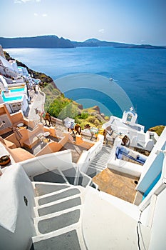 Oia town on Santorini island, Greece. Traditional and famous houses and churches with blue domes over the Caldera.