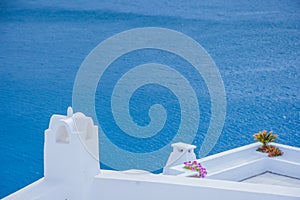 Oia town on Santorini island, Greece. Traditional and famous houses and churches with blue domes over the Caldera.