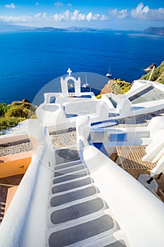 Oia town on Santorini island, Greece. Traditional and famous houses and churches with blue domes over the Caldera, Aegean sea