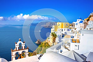 Oia town on Santorini island, Greece. Traditional and famous houses and churches with blue domes over the Caldera, Aegean sea