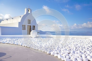 Oia town on Santorini island, Greece. Traditional and famous houses and churches with blue domes over the Caldera, Aegean sea