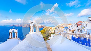 Oia town on Santorini island, Greece. Traditional and famous houses and churches with blue domes over the Caldera, Aegean sea