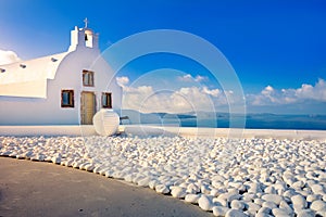 Oia town on Santorini island, Greece. Traditional and famous houses and churches with blue domes over the Caldera.