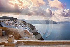 Oia town on Santorini island, Greece. Traditional and famous houses and churches with blue domes over the Caldera.