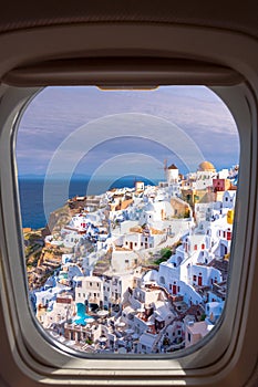 Oia town on Santorini island, Greece. Traditional and famous houses and churches with blue domes over the Caldera.