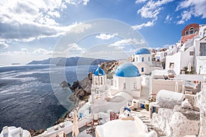 Oia village with churches against azure sea on Santorini island in Greece