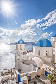 Oia village with churches against azure sea on Santorini island in Greece