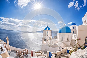 Oia village with churches against azure sea on Santorini island in Greece