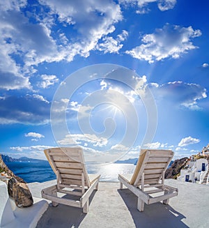 Oia village with sunbeds on Santorini island in Greece