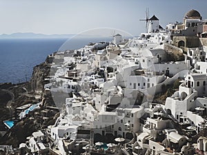 Oia village with traditional white architecture and windmills in Santorini island