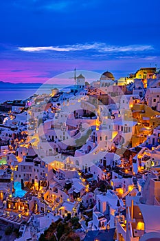 Oia village, windmills, Santorini island, Greece at colorful sunset