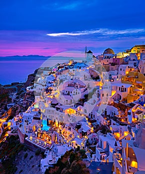 Oia village, windmills, Santorini island, Greece at colorful sunset