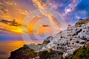 Oia village, windmills, Santorini island, Greece at colorful sunset