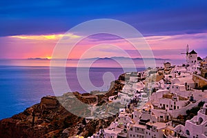 Oia village, windmills, Santorini island, Greece at colorful sunset