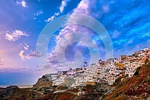 Oia village, windmills, Santorini island, Greece at colorful sunset