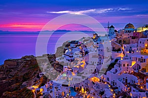 Oia village, windmills, Santorini island, Greece at colorful sunset