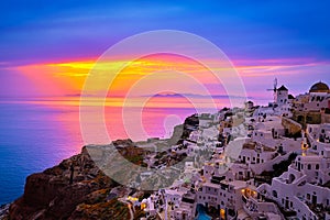 Oia village, windmills, Santorini island, Greece at colorful sunset