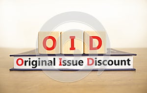 OID original issue discount symbol. Concept words OID original issue discount on beautiful wooden blocks and book. Beautiful white