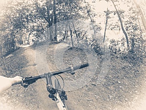 Oid vinage photo. Cyclist in the woods