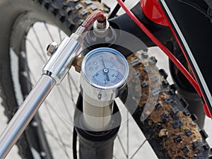 oil-air shock absorber using a specialized hand pump.