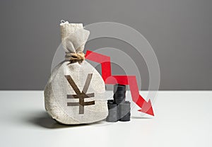 Oil barrels and chinese yuan or japanese yen money bag and red arrow down