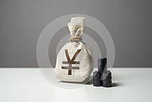 Oil barrels and japanese yen money bag. Buying futures for sale. photo