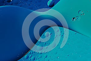 oil with bubbles on on dark blue background. Abstract background