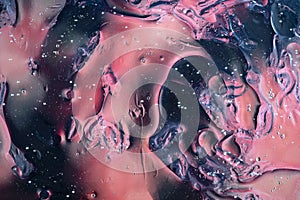 Oil bubbles on water abstract form in glass tank