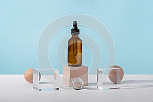 Oil cosmetics amber product packaging with stylish props. Serum cosmetic bottle with peptides and retinol on acrylic and