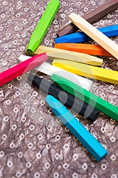Oil Crayons with Bright Colors close up on a decorate paper sheet