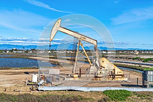 Oil derrick amid wetlands of Bolsa Chica Nature Reserve in Huntington Beach CA photo