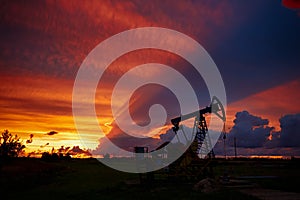 Oil derricks on a background of beautiful sunset