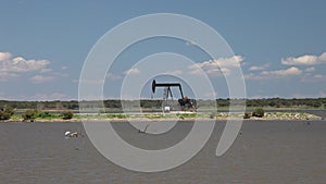 Oil derricks in hagerman wildlife refuge on lake Texoma.