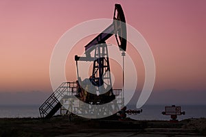 Oil derricks in sunset