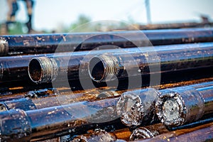 Oil Drill pipe. Rusty drill pipes were drilled in the well section. Downhole drilling rig.