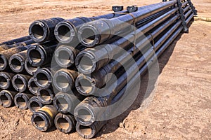 Oil Drill pipe. Rusty drill pipes were drilled in the well section. Downhole drilling rig. Laying the pipe on the deck. View of