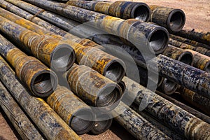 Oil Drill pipe. Rusty drill pipes were drilled in the well section. Downhole drilling rig. Laying the pipe on the deck. View of