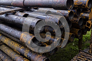 Oil Drill pipe. Rusty drill pipes were drilled in the well section. Downhole drilling rig. Laying the pipe on the deck. View of