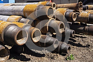 Oil Drill pipe. Rusty drill pipes were drilled in the well section. Downhole drilling rig. Laying the pipe on the deck. View of