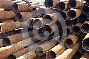 Oil Drill pipe. Rusty drill pipes were drilled in the well section. Downhole drilling rig. Laying the pipe on the deck. View of