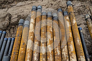 Oil Drill pipe. Rusty drill pipes were drilled in the well section. Downhole drilling rig. Laying the pipe on the deck. View of