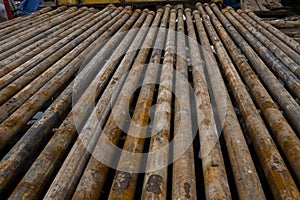 Oil Drill pipe. Rusty drill pipes were drilled in the well section. Downhole drilling rig. Laying the pipe on the deck. View of