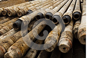 Oil Drill pipe. Rusty drill pipes were drilled in the well section. Downhole drilling rig. Laying the pipe on the deck. View of