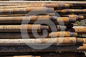 Oil Drill pipe. Rusty drill pipes were drilled in the well section. Downhole drilling rig. Laying the pipe on the deck. View of