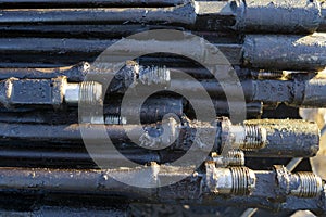 Oil Drill pipe. Rusty drill pipes were drilled in the well section. Downhole drilling rig. Laying the pipe on the deck. View of