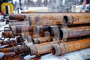 Oil Drill pipe. Rusty drill pipes were drilled in the well section. Downhole drilling rig. Laying the pipe on the deck. View of